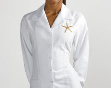Women's fitted shirt with embroidered corporate logo for Jumby Bay Resort, Antigua